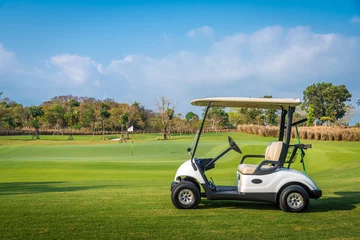 Fotobehang Golf Golf cart park on green grass in golf course ,beautiful view of golf course and sun sky background  © APchanel