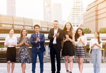 Business people clap hands after finishing up a meeting outdoor,Successful diversity group of business people,Teams success achievement