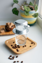 alternative method of brewing coffee. Filter with ground coffee and glass. vietnamese filter for espresso. morning routine concept