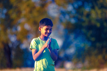 Indian child playing with the color in holi festival