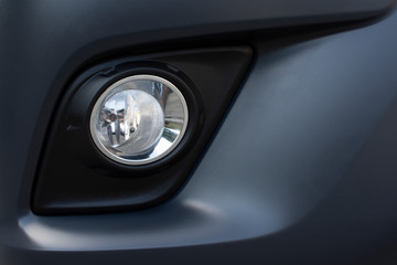 Obraz na płótnie Canvas Fog light on front bumper of a car.