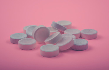Obraz na płótnie Canvas Many Tablets (pills) on pink color background.