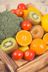 Fresh fruits with vegetables in rustic box as food containing healthy minerals and vitamins