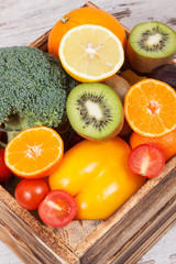 Fresh fruits with vegetables in rustic box as food containing healthy minerals and vitamins