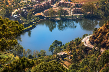 Aerial view of scenic mountain lake with cityscape as viewed from a mountain top at Munsiyari Uttarakhand India. 