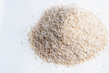 Bran oatmeal coarse, useful, cleansing, for healthy eating on a white background