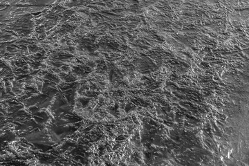 River ice texture background close up. Black and white
