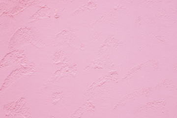 Texture of plastered wall. Textured pink color handmade surface for background. Color of the year 2019 - living coral.Building wall texture in pink, living corall color