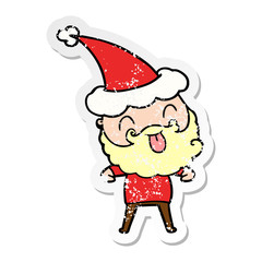 man with beard sticking out tongue wearing santa hat