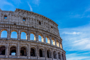Facade of the Great Roman Colosseum (Coliseum, Colosseo), also known as the Flavian Amphitheatre. Famous world landmark. Scenic urban landscape.