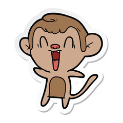 sticker of a cartoon laughing monkey