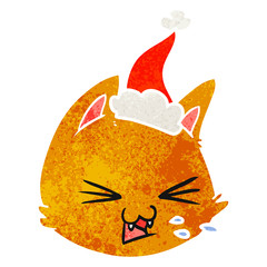 Obraz premium spitting retro cartoon of a cat face wearing santa hat