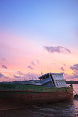 Fototapeta na wymiar old fishing boat at sunset