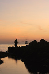 Naklejka na ściany i meble fishing at sunset