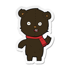 sticker of a cartoon waving black bear cub with scarf