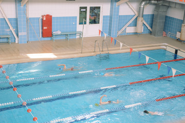 Swim in swiming pool. Closed pool. Swim for speed. Swimming competition.
