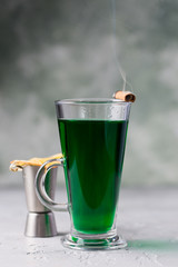 green warm cocktail with dried fruits and spices