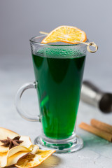 green warm cocktail with dried fruits and spices