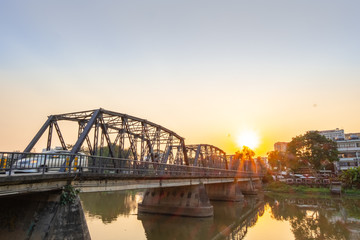 Iron bridge in Chiangmai during sunset time with beautiful lens flare.