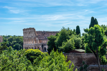 Fototapeta premium Facade of the Great Roman Colosseum (Coliseum, Colosseo), also known as the Flavian Amphitheatre. Famous world landmark. Scenic urban landscape.