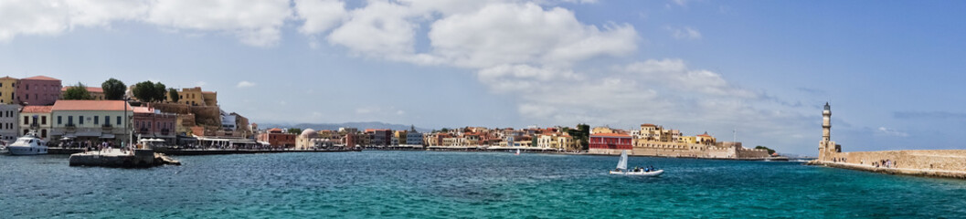 Fototapeta na wymiar Panoramic view of the old venetian harbor with a lighthouse at Chania, island of Crete, Greece