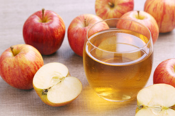 A glass with juice and apples