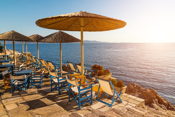 Cafe with umbrellas overlooking the sea. Hydra island, Greece.