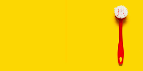 Bright red brush lies on a bright yellow background. In the style of pop art. Top view. Copy space.