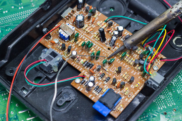 Technician repairing electronic of the computer's circuit board by soldering Irons, concept ...