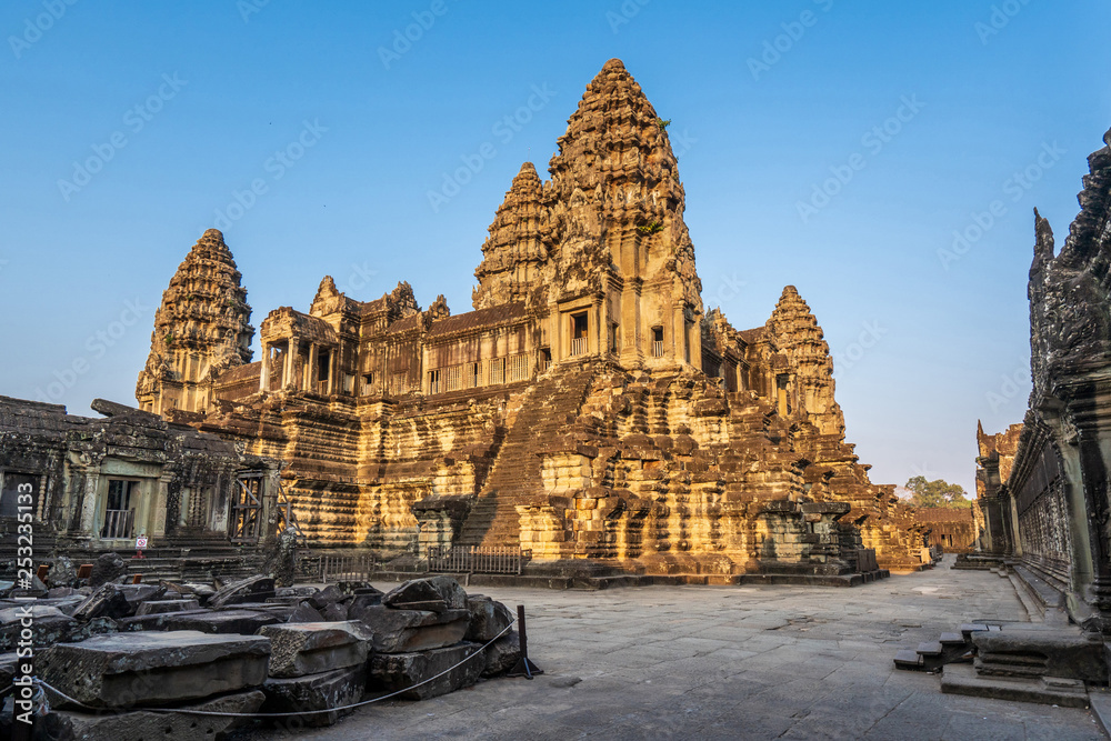 Wall mural Third level with towers and covered galleries of Angkor Wat temple in golden sunset light