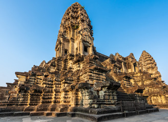 Third level with towers and covered galleries of Angkor Wat temple in golden sunset light