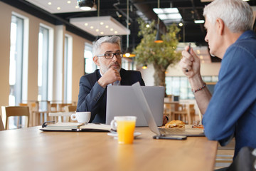 Work colleagues discussing ideas in informal business meeting