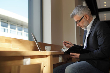 Businessman working waiting for flight in modern airport