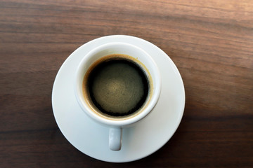 Hot coffee on wood background, black coffee.
