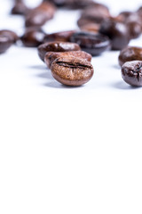 Roasted coffee beanon white