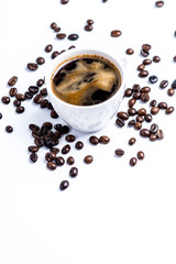 Cup with coffee beans on white background