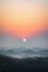 An early morning winter sunrise with fine layer of mist at the most iconic Qutub Minar in the capital city of New Delhi.