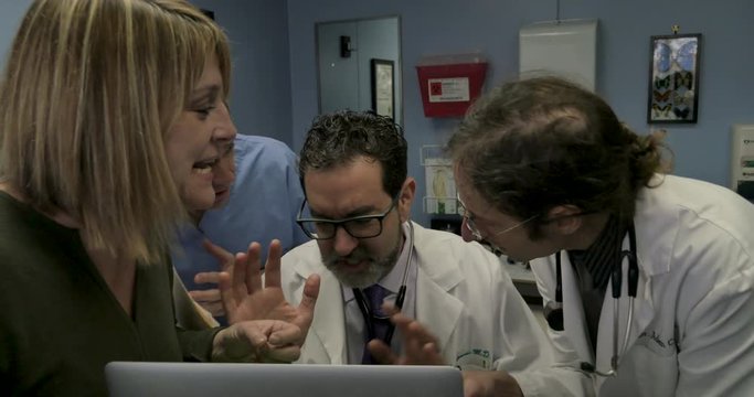 Doctor freaking out while multitasking when three other people talk at him