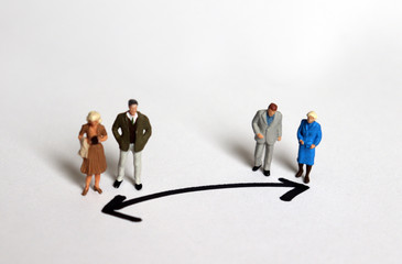 Miniature people who stand in a different direction. 