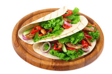 Tortilla wrap with fried chicken meat and vegetables on wooden board isolated on white background