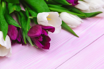 Bouquet of tulip flowers on pink wood background with copy space