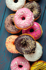 Glazed donuts on wooden background