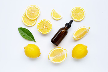 Fresh lemon with lemon essential oil on white background.