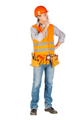 Portrait of a male builder in a helmet  looking at camera over white wall background. repair, construction, building, people and maintenance concept.