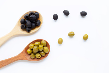 Olives on wooden spoon, white background.