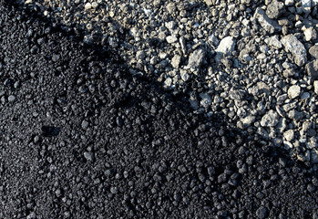 Stones on the edge of the asphalt road