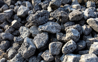 Stones on the edge of the asphalt road