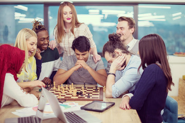 multiethnic group of business people playing chess