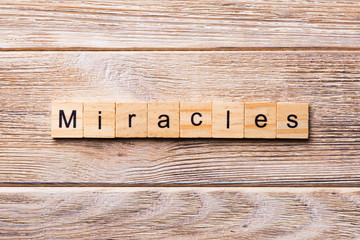 miracles word written on wood block. miracles text on wooden table for your desing, concept