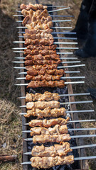 Shish kebab on skewers is fried on a brazier